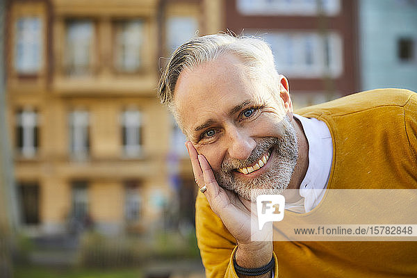 Portrait of smiling mature man in the city