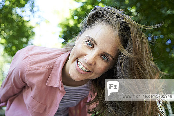 Portrait of happy brunette woman outdoors