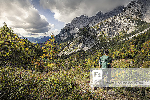 Woman on a hiking trip at Wilder Kaiser enjoying the view  Kaiser mountains  Tyrol  Austria
