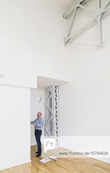 Man checking specifications of refurbished kuxury loft