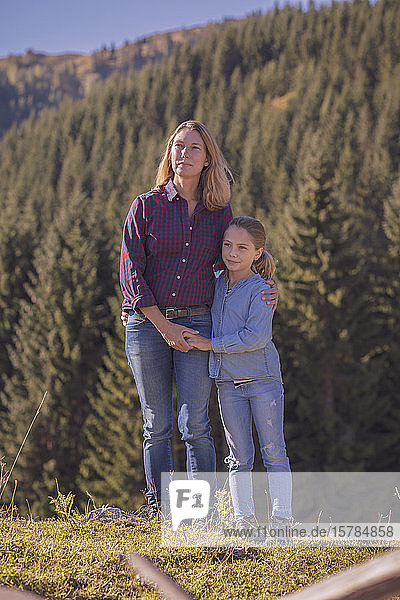 Mother and daughter hiking in the mountains  hugging