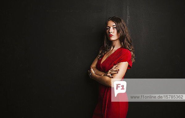 Portrait of young woman wearing red dress