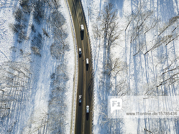 Russia Saint Petersburg Aerial view of cars driving along country road in winter