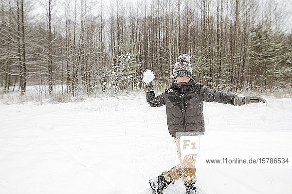 Boy throwing snowball