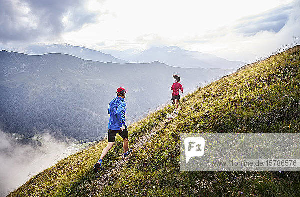 Man and woman running in the mountains