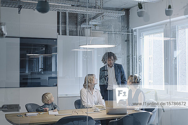 Business team with a boy having a meeting in office