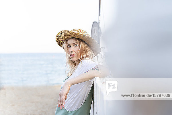 Young woman spending a day at the seaside  wearing straw hat