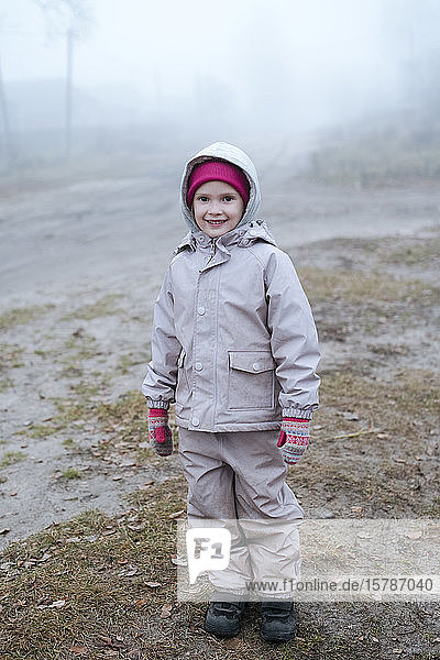Portrait of smiling little girl in winter
