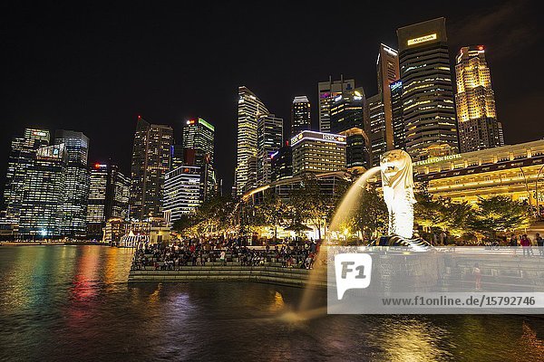 Merlion fountain and business district at night Singapore Republic of Singapore.