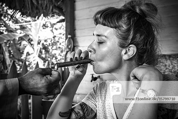 Gorl smoking a cigar at a Tobacco Farm  Republic of Cuba  Caribbean  Central America.