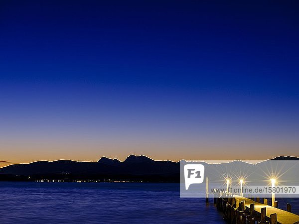 Steg am Chiemsee bei Morgendämmerung hinten die Chiemgauer Alpen Chiemgau Oberbayern Bayern Deutschland Europa