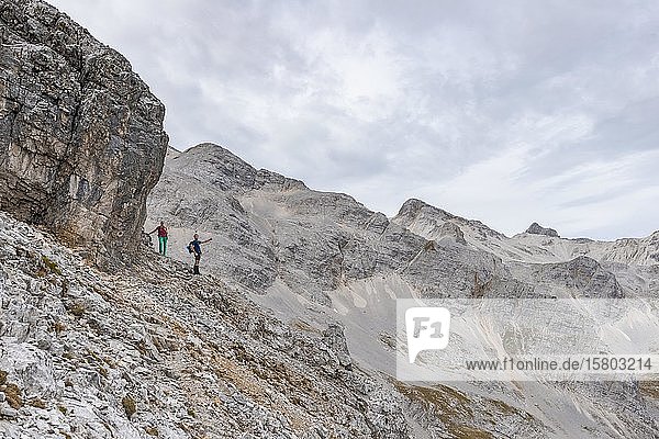 Two hikers on a hiking trail to the Birkkarspitze and Ödkarspitze  Karwendeltal  Tyrol  Austria  Europe