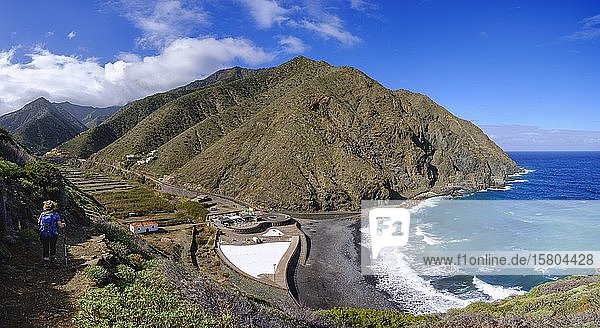Woman hiking on hiking trail via Playa del Vallehermoso  open air pool and Castillo del Mar  near Vallehermoso  La Gomera  Canary Islands  Spain  Europe