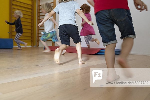 Children run romp barefoot in kindergarten Cologne North Rhine-Westphalia Germany Europe