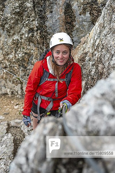 Young woman  hiker climbing a via ferrata Vandelli  Sorapiss Circuit  Dolomites  Belluno  Italy  Europe
