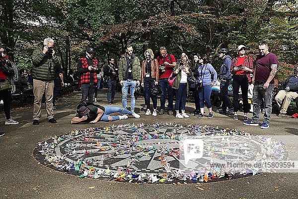 Tourists photograph the John Lennon Memorial Strawberry Fields Central Park Manhattan New York City New York State USA North America