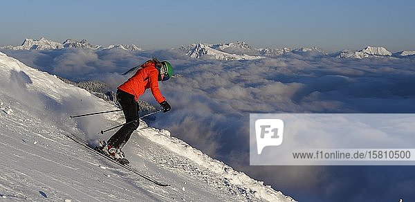 Female skier descending steep slope  black slope  mountains behind  SkiWelt Wilder Kaiser  Brixen im Thale  Tyrol  Austria  Europe