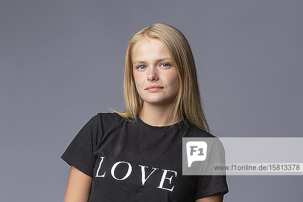 Portrait confident young blonde woman in love t-shirt
