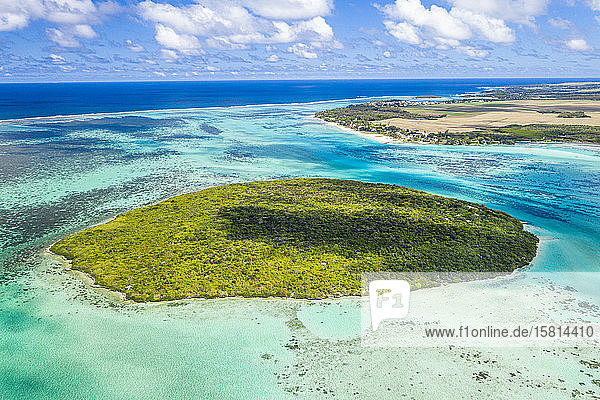 Lush vegetation on Ile aux Aigrettes atoll in the turquoise lagoon aerial view by drone Pointe d'Esny Mahebourg Mauritius Indian Ocean Africa