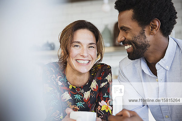 Portrait smiling  happy multi-ethnic couple drinking coffee