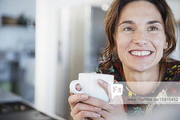 Portrait smiling brunette woman drinking coffee