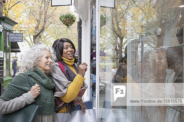 Senior women window shopping at urban storefront
