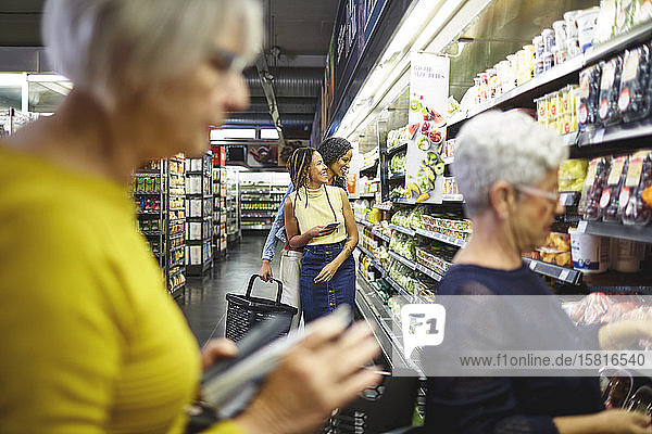 Women grocery shopping in supermarket