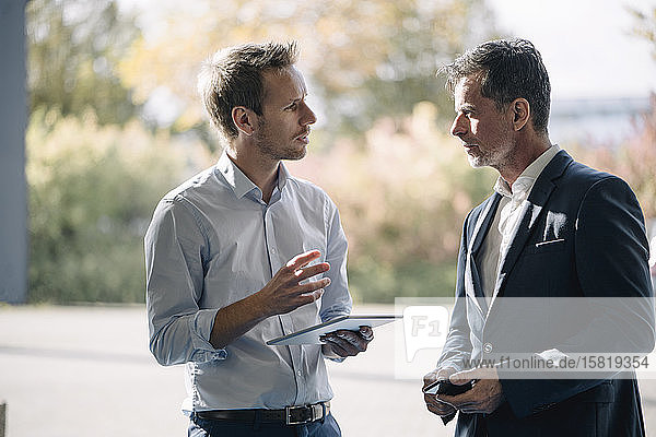 Two businessmen talking at the window