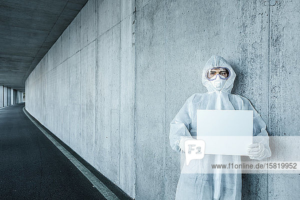 Porträt eines Mannes in Schutzkleidung mit einem leeren Schild