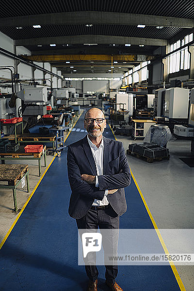 Porträt eines lächelnden Geschäftsmannes in einer Fabrik