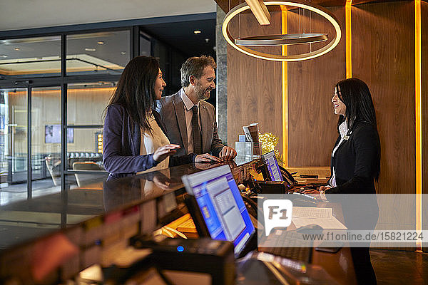 Business people at reception desk in hotel lobby