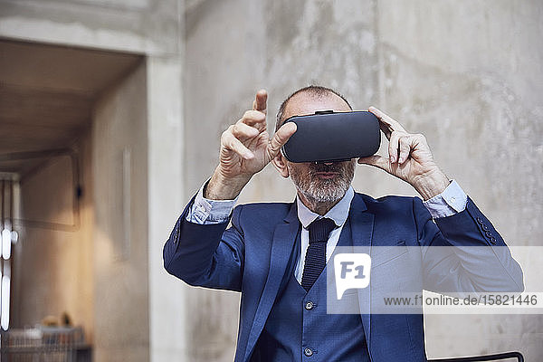 Senior businessman using VR glasses