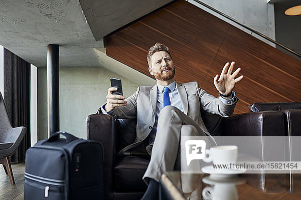 Businessman relaxing in hotel lobby