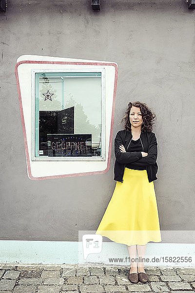 Porträt einer brünetten Frau neben einem Fenster eines Retro-Bistros