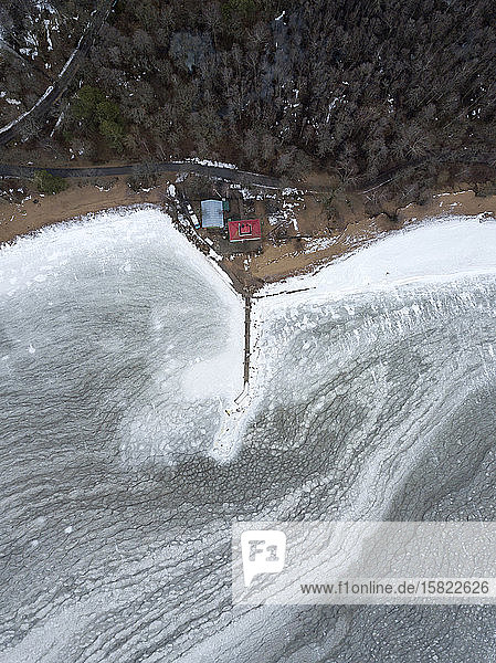 Russia Saint Petersburg Sestroretsk Aerial view of secluded houses and pier on frozen shore of Gulf of Finland