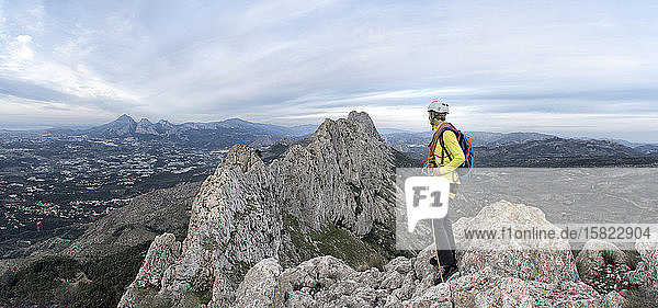 Woman mountaineering at Bernia Ridge looking at view  Costa Blanca  Alicante  Spain