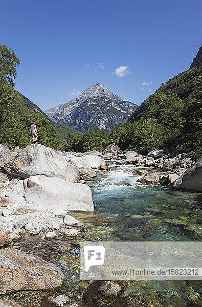 Man standing on rock at Verzasca river  Verzasca Valley  Ticino  Switzerland