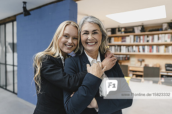 Portait of happy mature and young businesswoman in loft office
