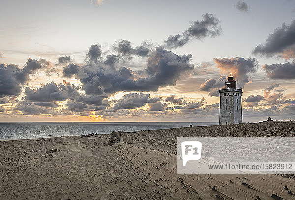 Denmark  Lonstrup  Clouds over Rubjerg Knude Lighthouse at dusk with North Sea in background