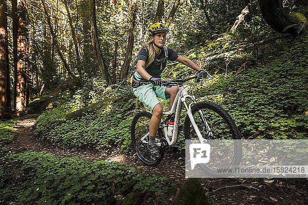 Woman riding mountainbike on forest track  Santa Cruz  California  USA