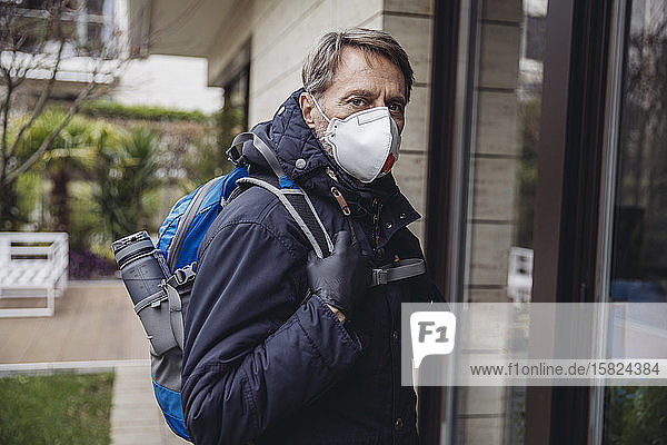 Matuer man commuting in the city  wearing protective mask
