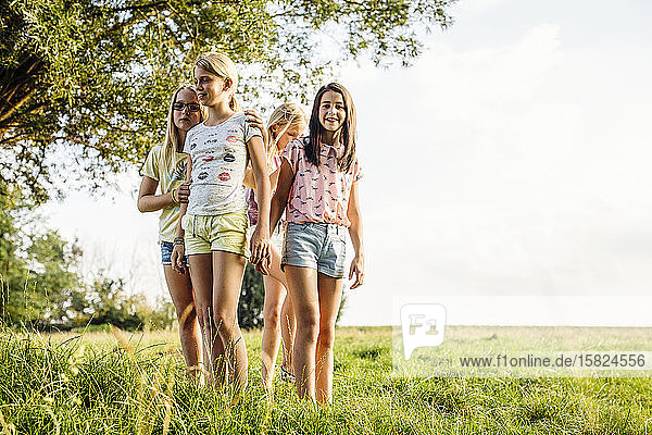 Girls standing on a field in the countryside
