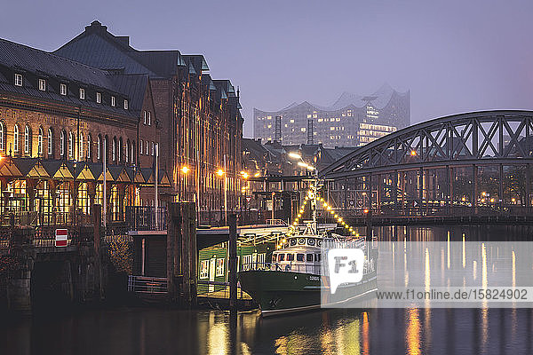 Germany  Hamburg  Boat moored in front of bridge over Elbe canal with Elbphilharmonie in background
