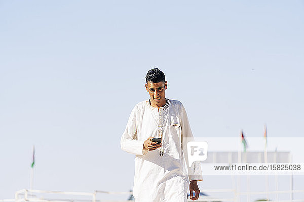 Portrait of man with mobile phone in Smara refugee camp  Algeria