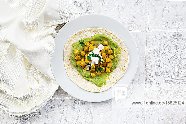 Fladenbrot mit pürierten Avocados Kurkuma-Kichererbsen Joghurt und Petersilie