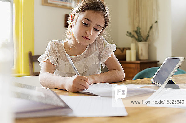 Girl (6-7)Â working on schoolwork at home