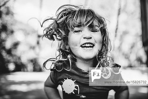 young girl swinging and laughing
