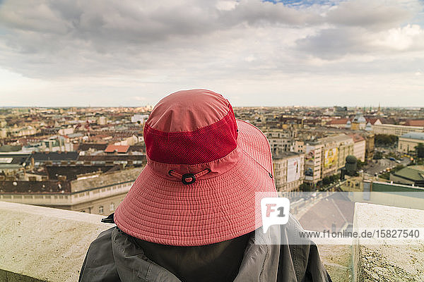 Dame mit Hut  die von der Stephansbasilika aus die Aussicht auf Budapest genießt