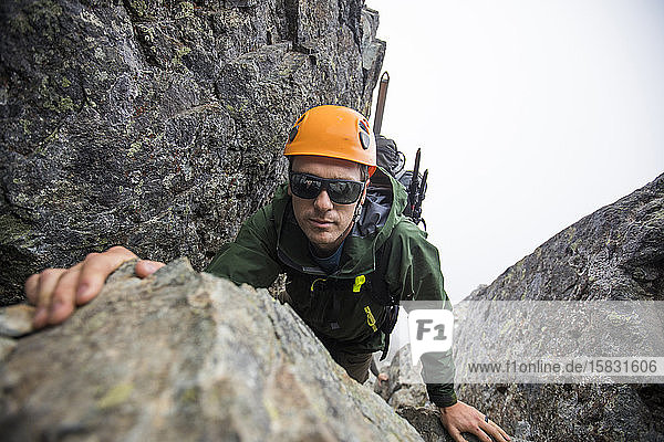 Man climbing on Sky Pilot Mountain  B.C.  Canada