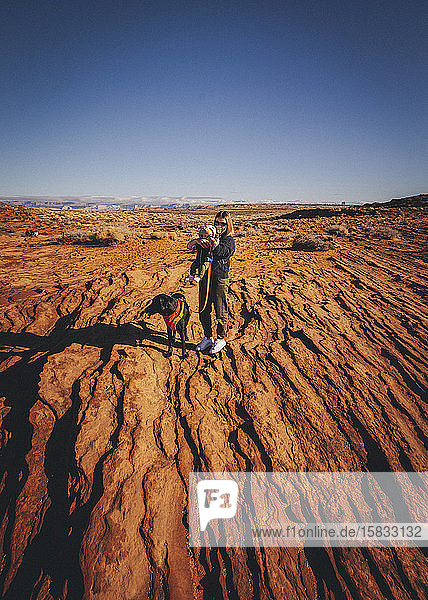 A woman with a dog and a child is standing near Horseshoe Bend Arizona